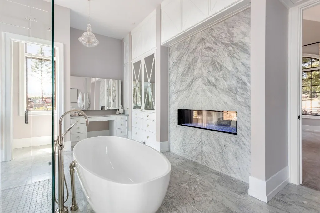 Dark tile shower remodel with pebble floor detail