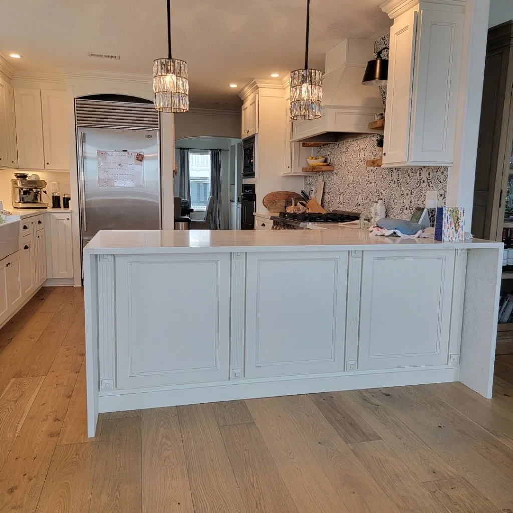 Kitchen work zone with stone counters and hardwood flooring