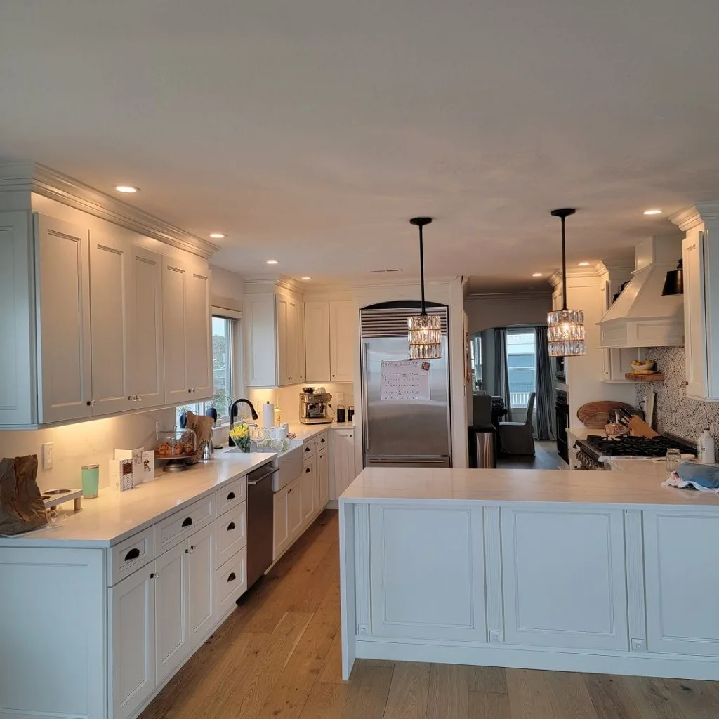 White kitchen remodel with farmhouse sink and center island