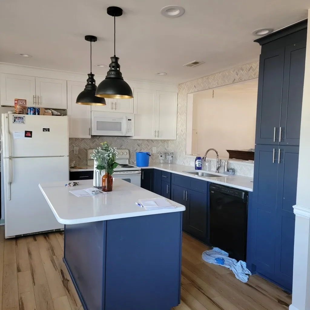 Classic white kitchen with granite counters and sunny window wall