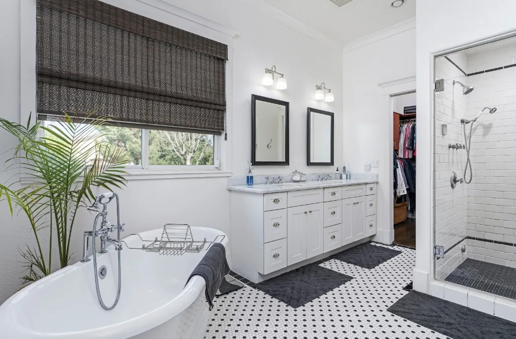 Blue tile bathroom concept with long vanity and round mirror