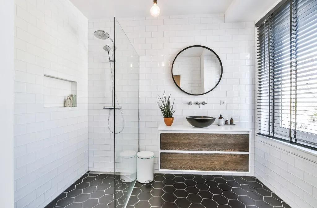 Bright attic bathroom with dual vessel sinks and freestanding tub
